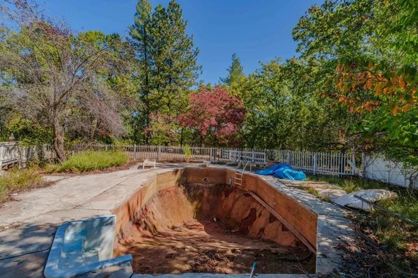 a view of a swimming pool with a yard