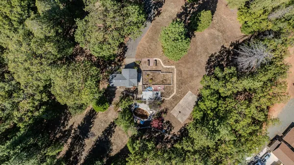 an aerial view of a house with a yard and garden