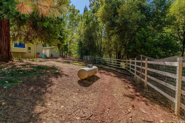 a view of a backyard with wooden fence