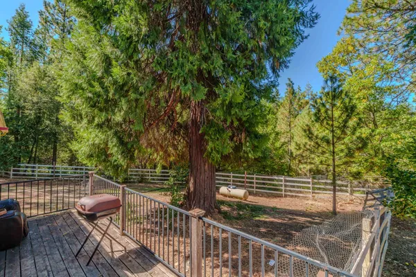 a view of balcony with wooden floor and fence