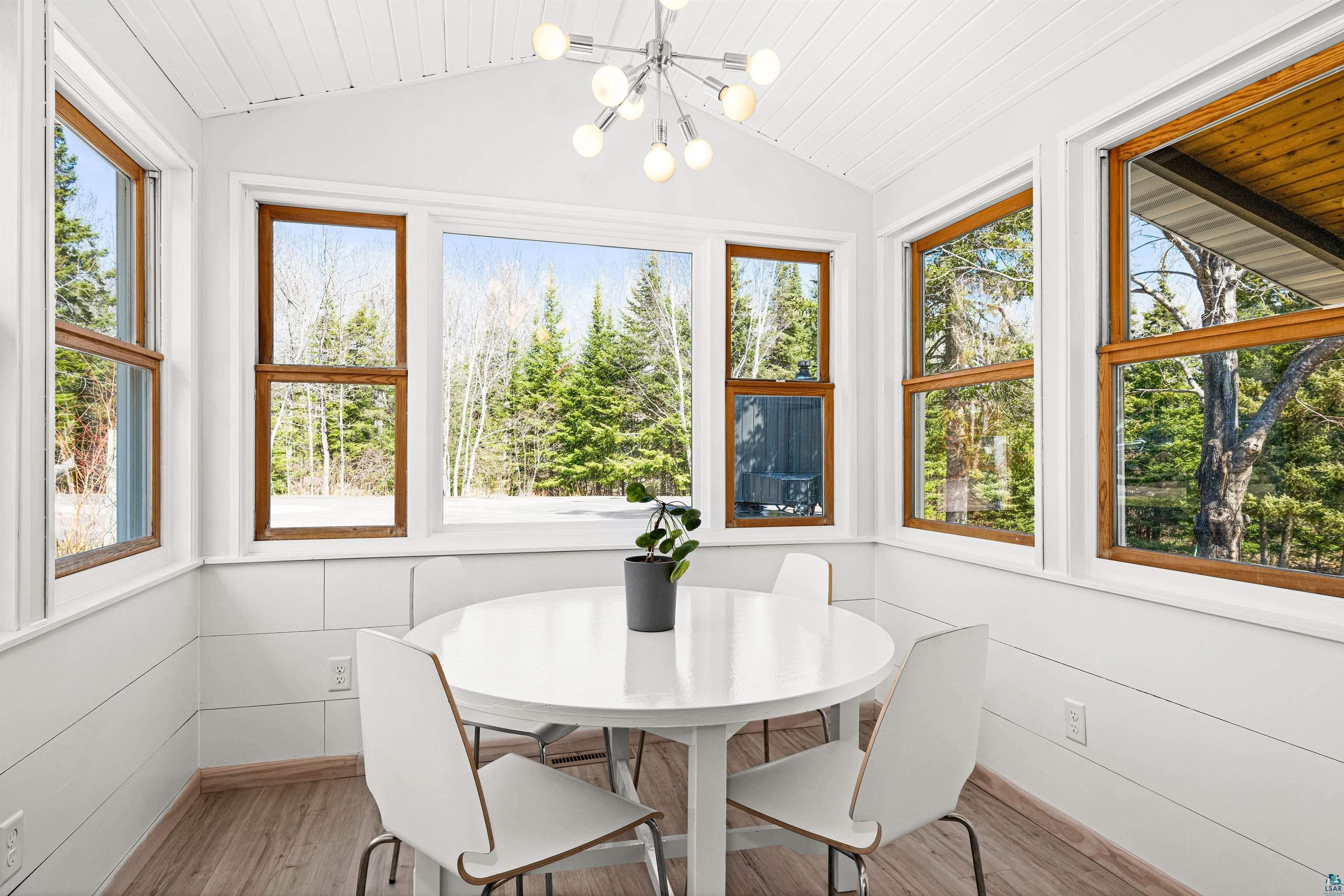 5638 Bergquist Road Duluth, MN 55804 - Photo 14 of 43 Sunroom / solarium with wood finished floors, a notable chandelier, wood ceiling, and vaulted ceiling