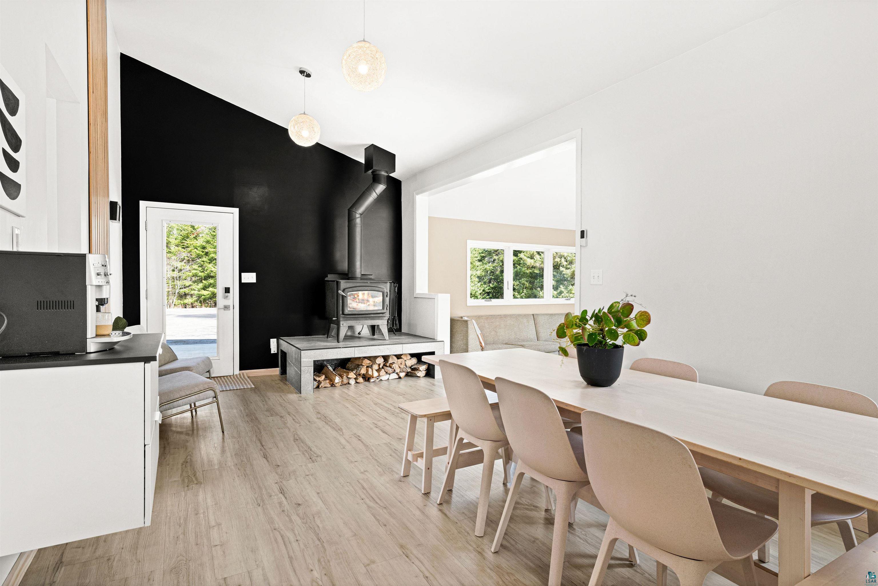 5638 Bergquist Road Duluth, MN 55804 - Photo 15 of 43 Dining area featuring a wood stove and light wood-style flooring