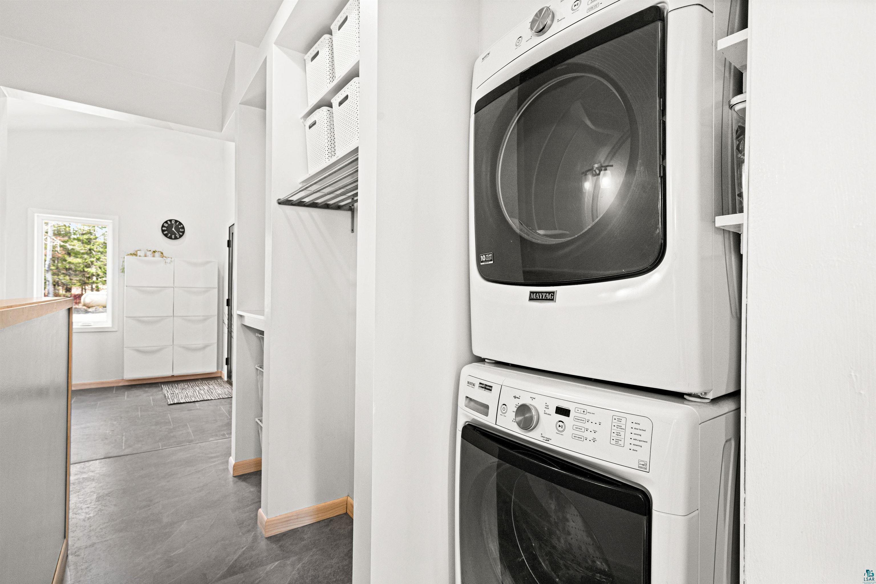 5638 Bergquist Road Duluth, MN 55804 - Photo 24 of 43 Laundry room with stacked washer and dryer, laundry area, and baseboards