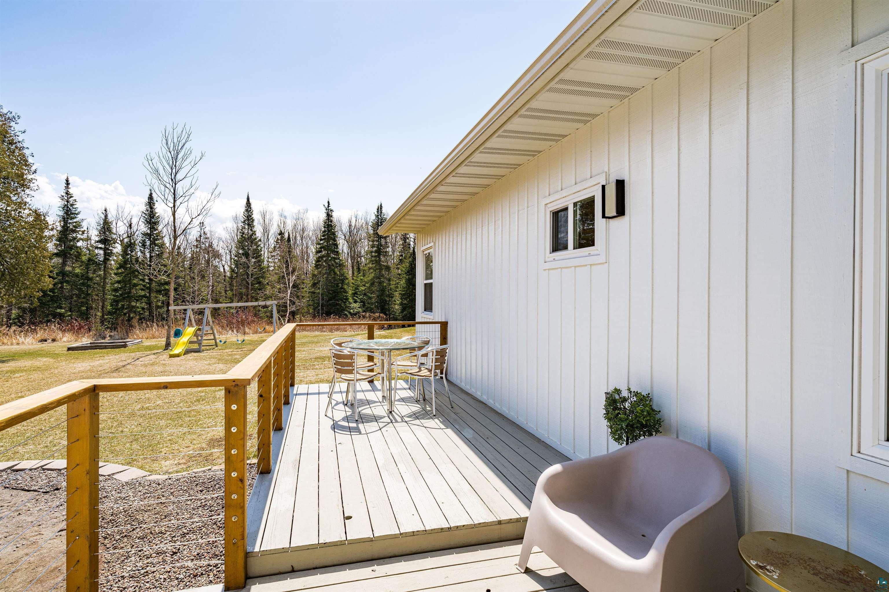 5638 Bergquist Road Duluth, MN 55804 - Photo 8 of 43 Wooden deck with outdoor dining area and a playground