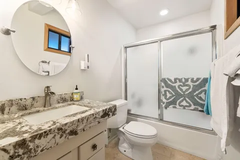 a bathroom with a sink toilet and shower