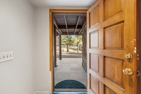 a view of a balcony with furniture and wooden floor