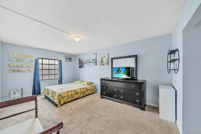 a bedroom with a bed and a dresser in it