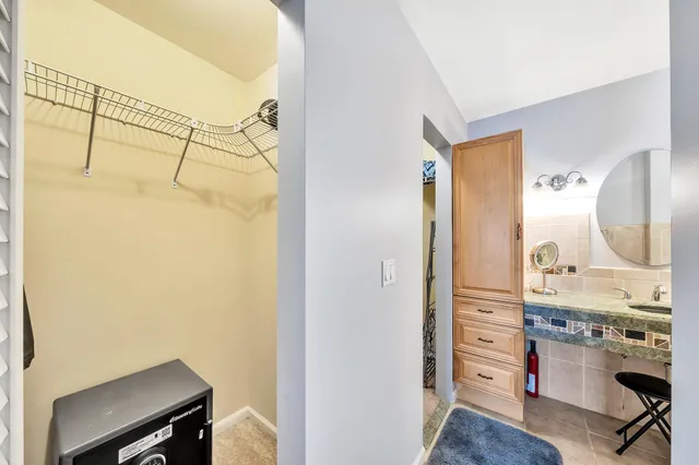 a bathroom with a granite countertop shower and a sink