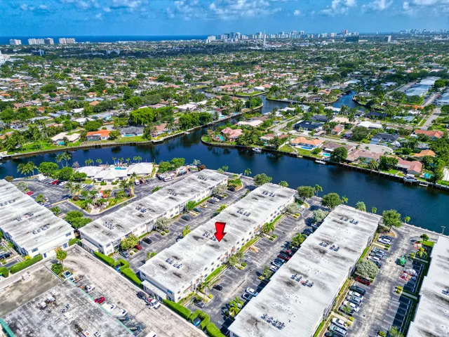 an aerial view of a house with a yard and lake view