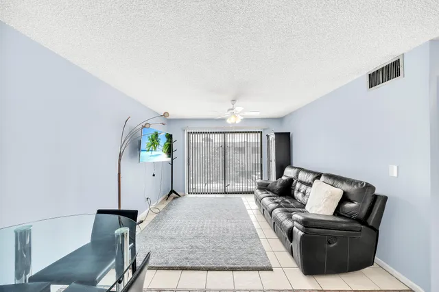 a living room with furniture rug and a window