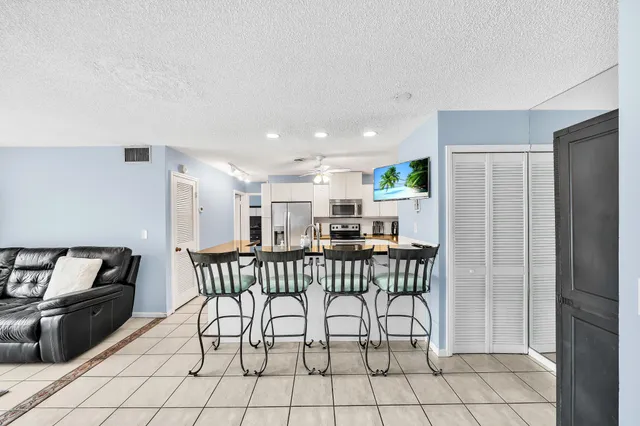 a kitchen with white cabinets stainless steel appliances and sink