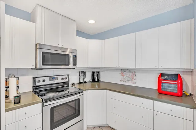 a kitchen with a sink and refrigerator