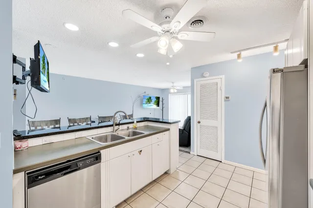 a kitchen with stainless steel appliances a refrigerator sink and cabinets