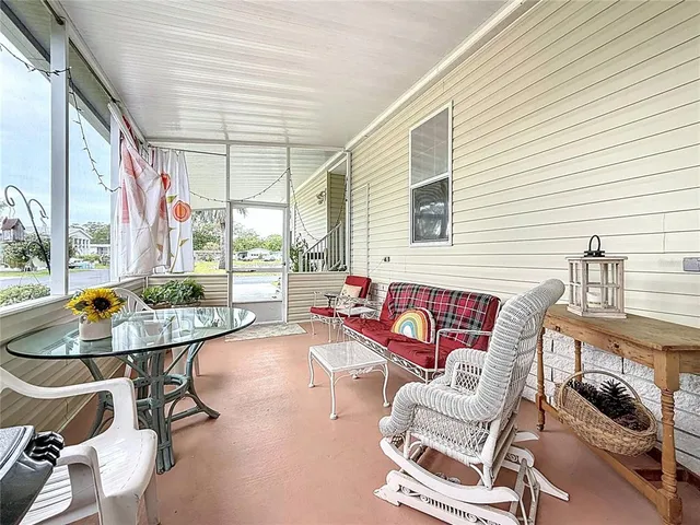 a balcony with furniture and a large window