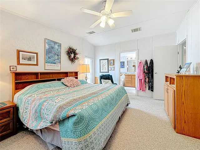 a bedroom with bed and a chandelier