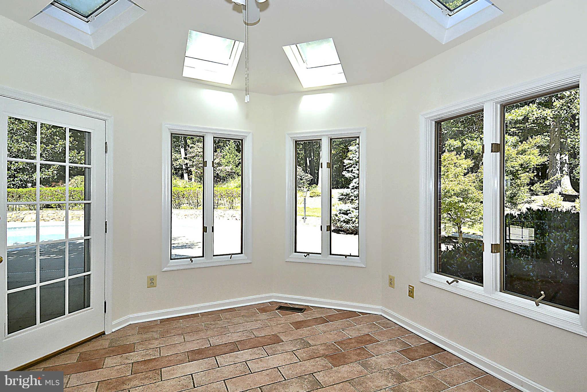 720 Clear Spring Road Great Falls, VA 22066 - Photo 6 of 30 Sunroom off kitchen has atrium door to pool