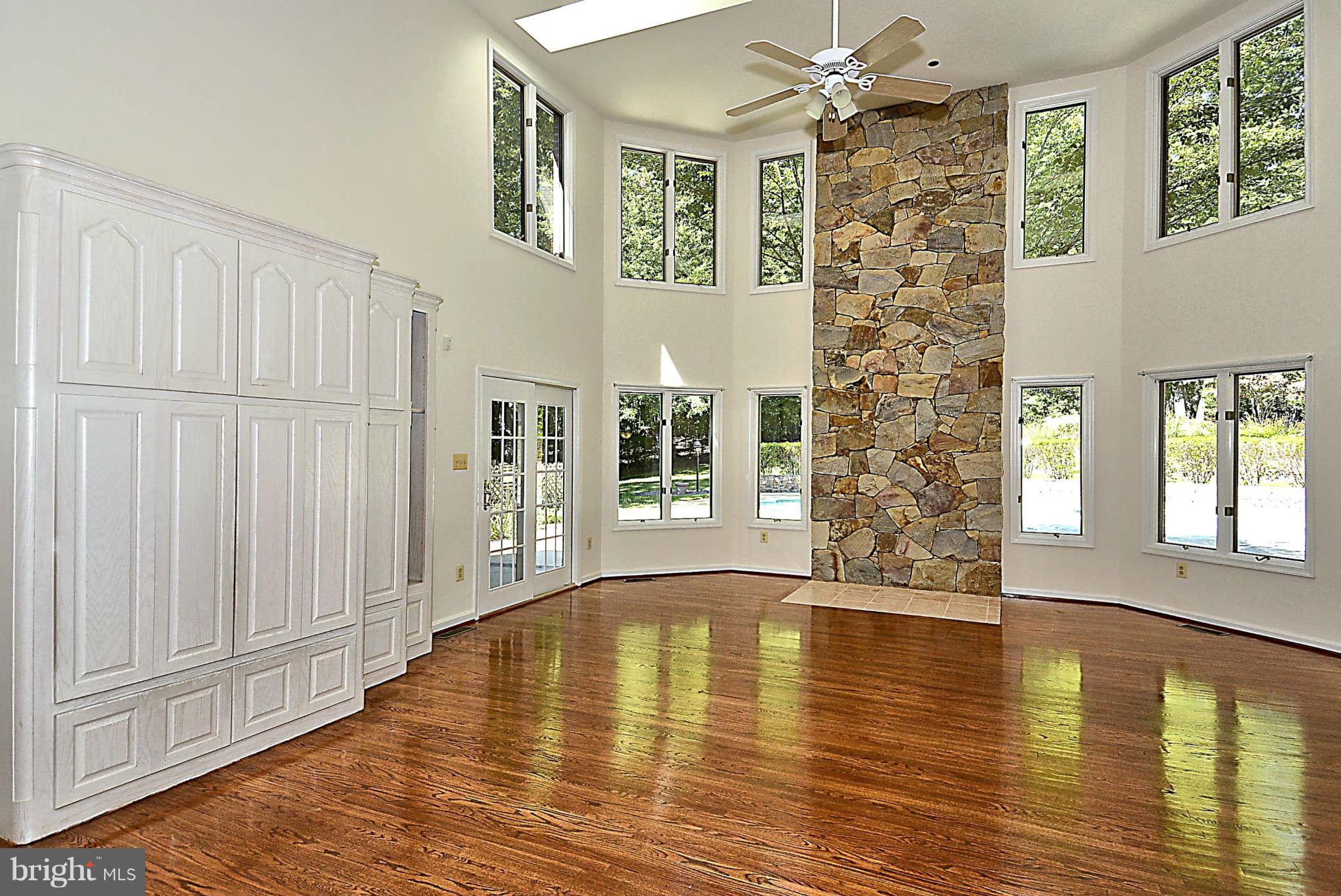 720 Clear Spring Road Great Falls, VA 22066 - Photo 7 of 30 Soaring ceiling, stone accent wall & pool views