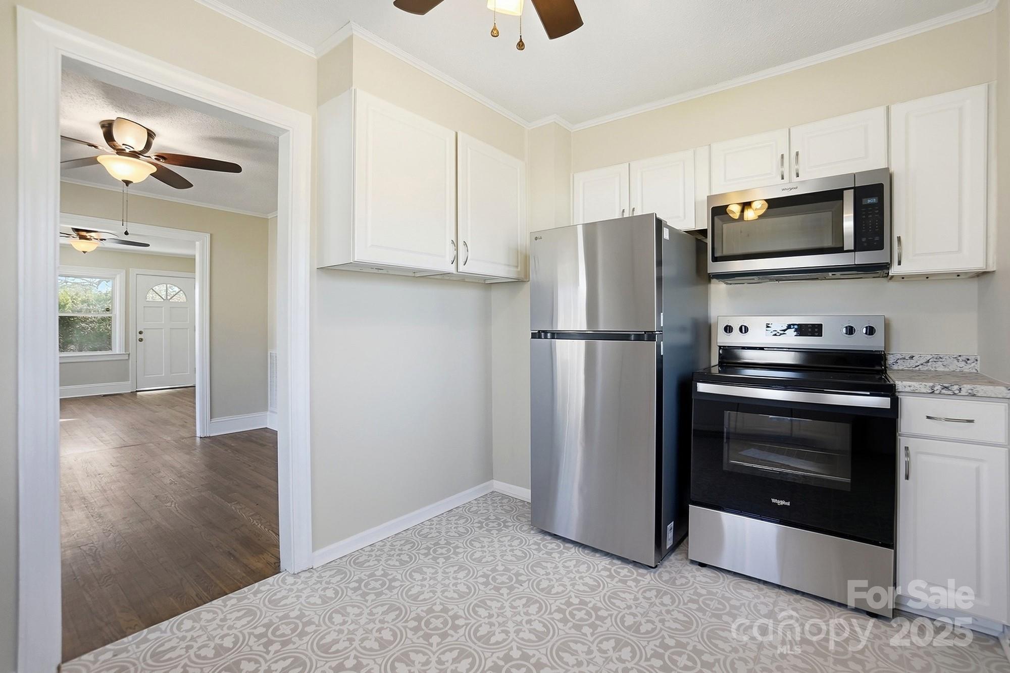 412 Ridge Street Stanley, NC 28164 - Photo 11 of 30 a kitchen with stainless steel appliances granite countertop a refrigerator and a stove top oven