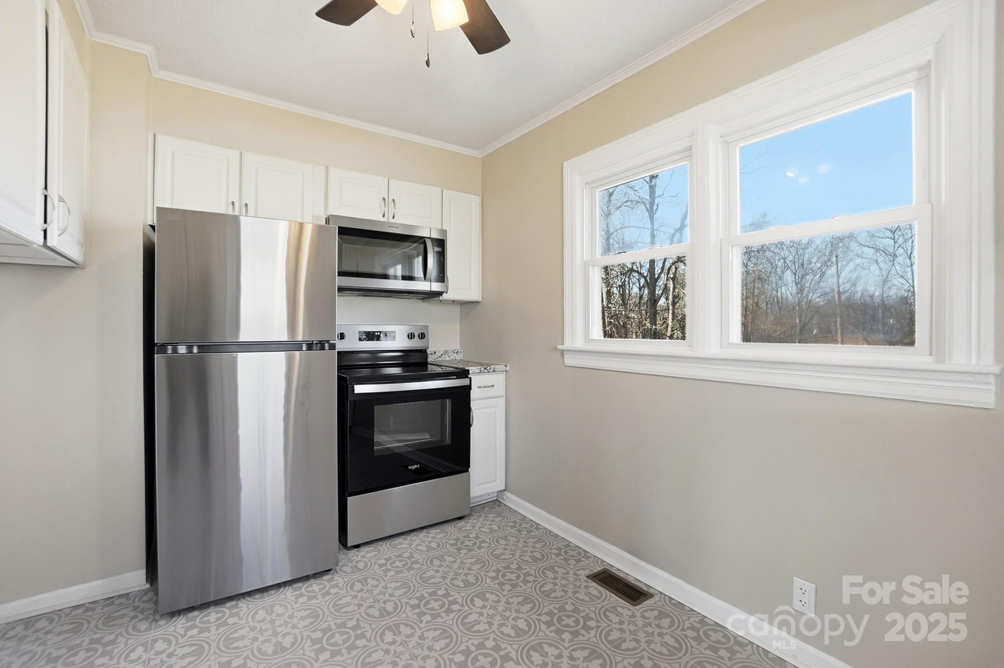 412 Ridge Street Stanley, NC 28164 - Photo 12 of 30 a kitchen with stainless steel appliances a refrigerator and a stove top oven