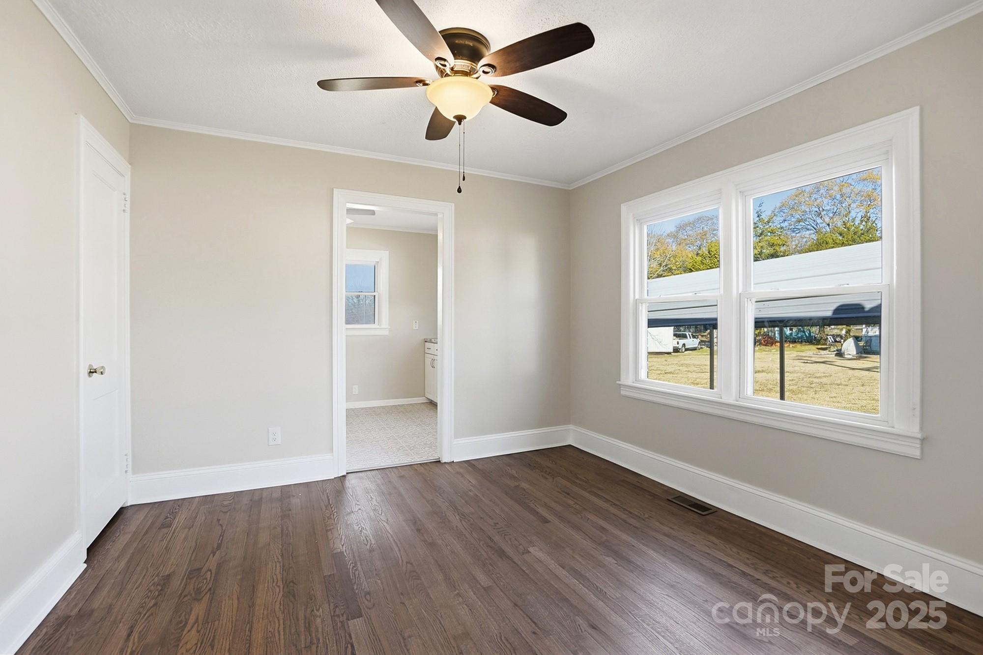 412 Ridge Street Stanley, NC 28164 - Photo 14 of 30 a view of an empty room with wooden floor and a window