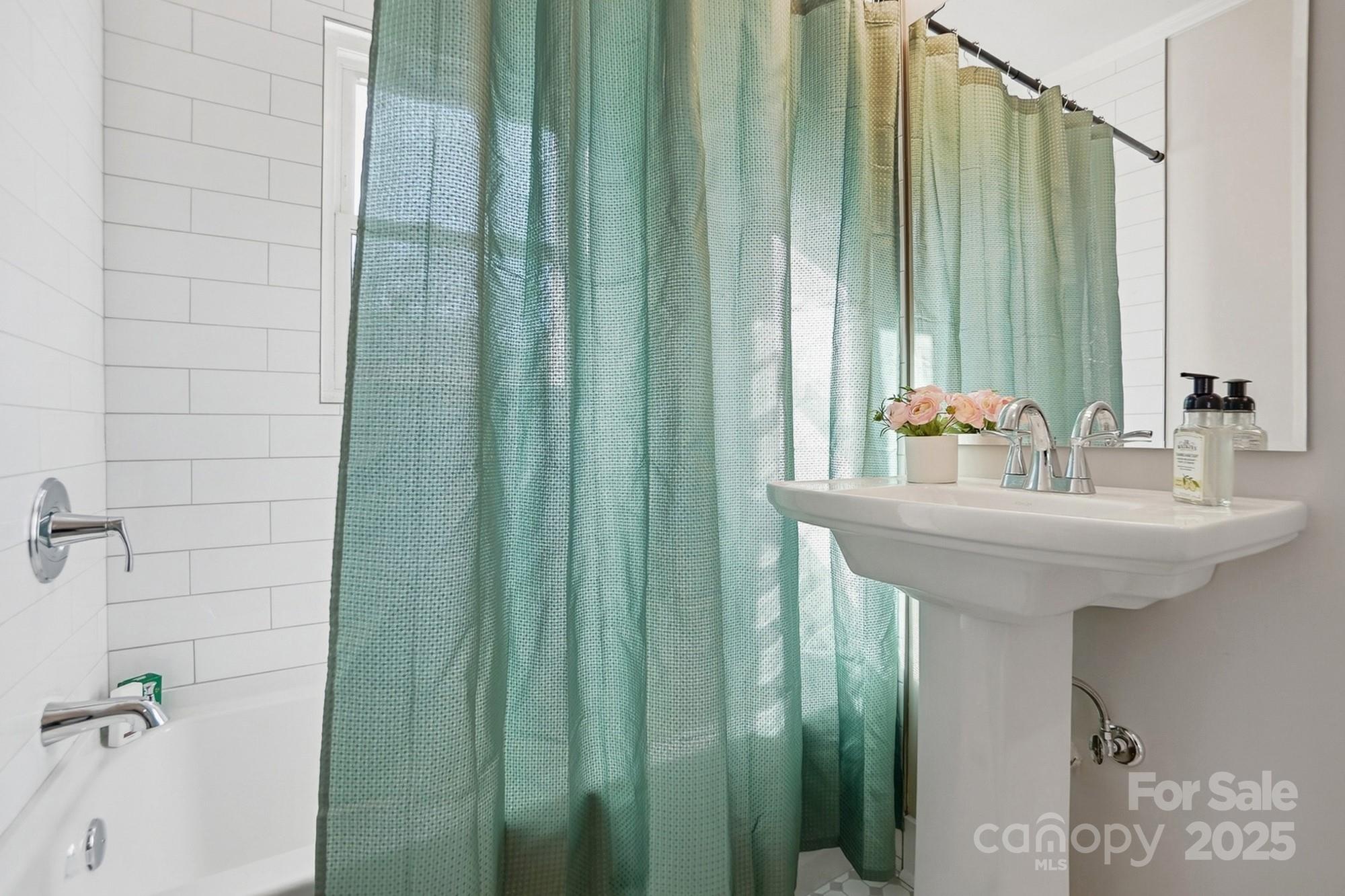 412 Ridge Street Stanley, NC 28164 - Photo 20 of 30 a bathroom with a sink a mirror and a shower