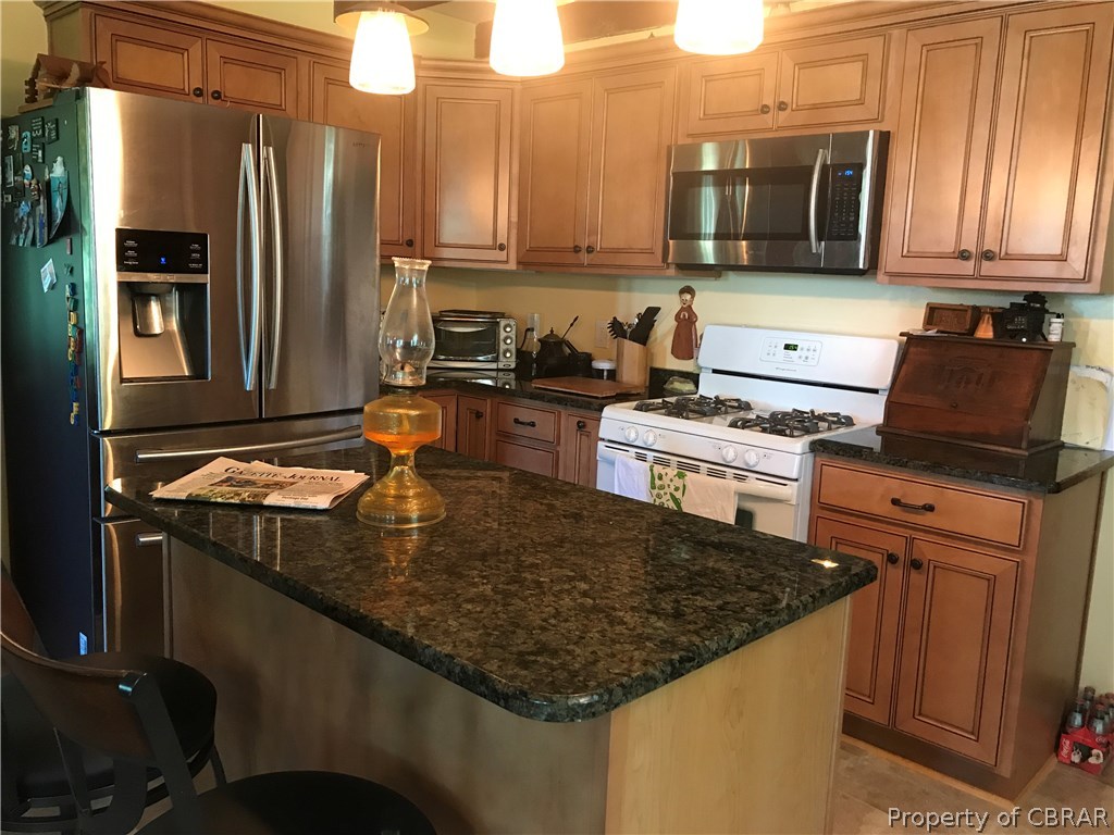 391 Haven Beach Road Moon, VA 23119 - Photo 4 of 43 a kitchen with kitchen island granite countertop a stove top oven a sink and a refrigerator