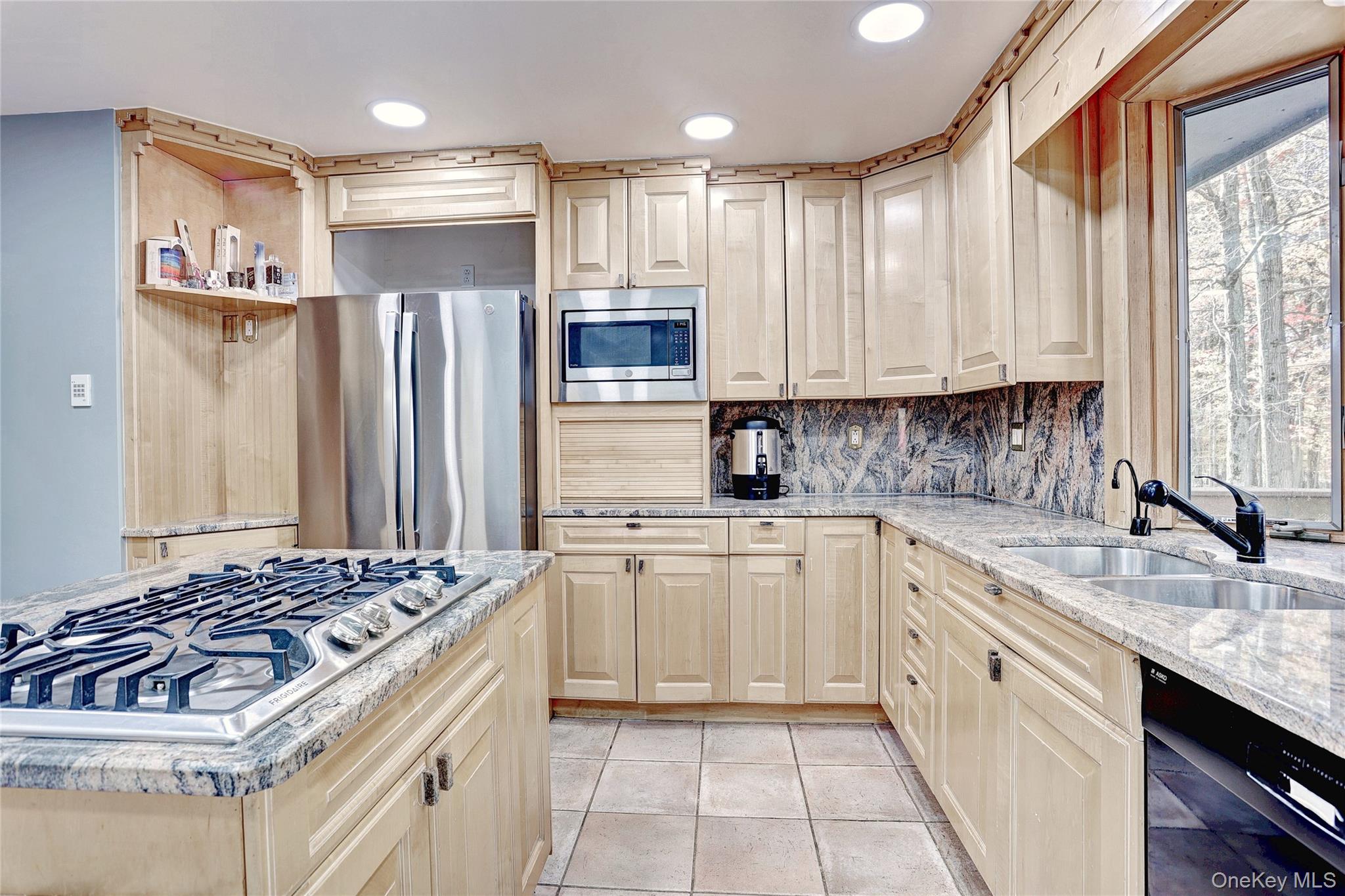 23 Sherwood Ridge Road Pomona, NY 10970 - Photo 11 of 28 a kitchen with kitchen island granite countertop a sink stove and refrigerator