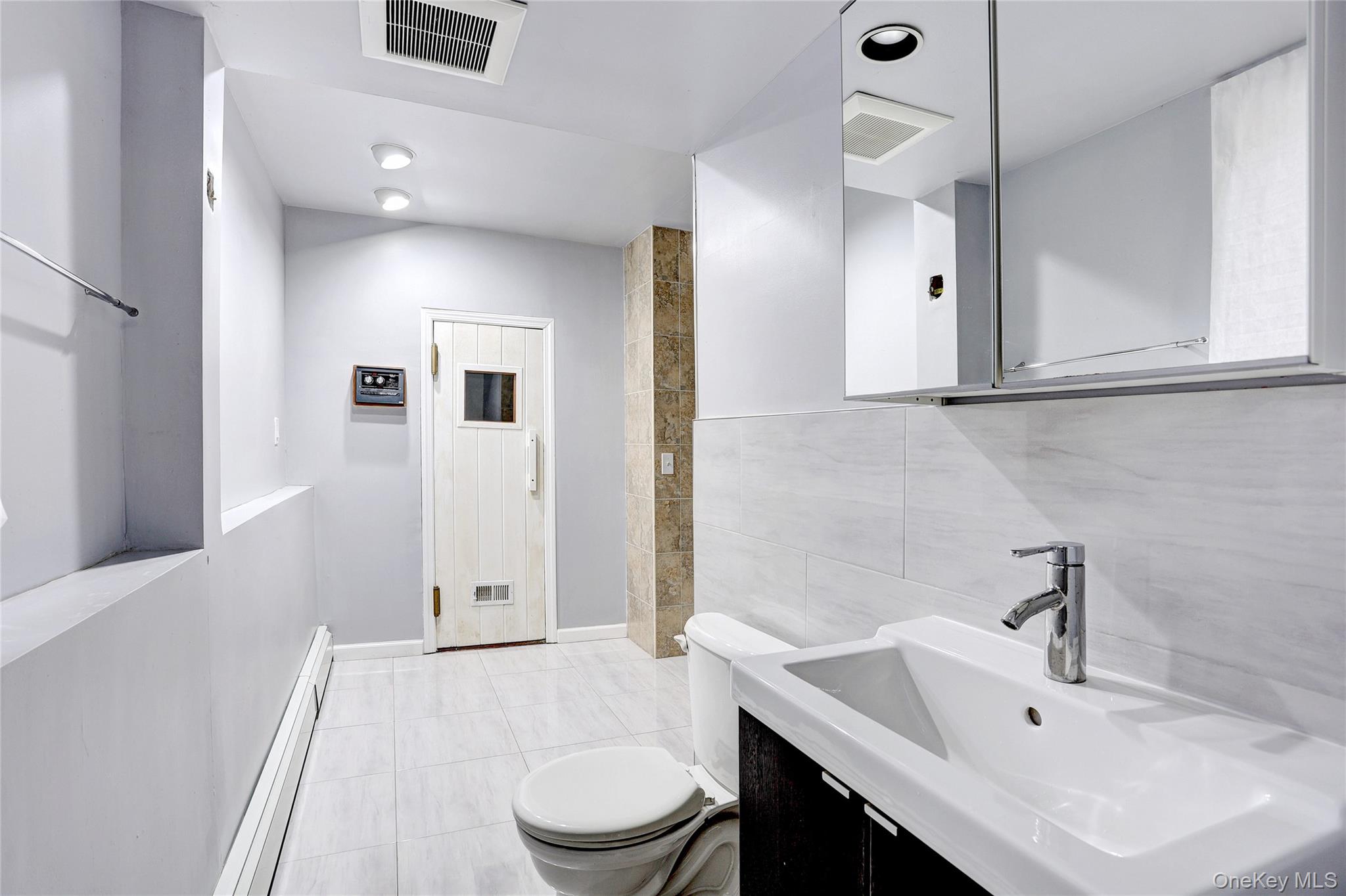 23 Sherwood Ridge Road Pomona, NY 10970 - Photo 22 of 28 a bathroom with a sink a toilet and shower