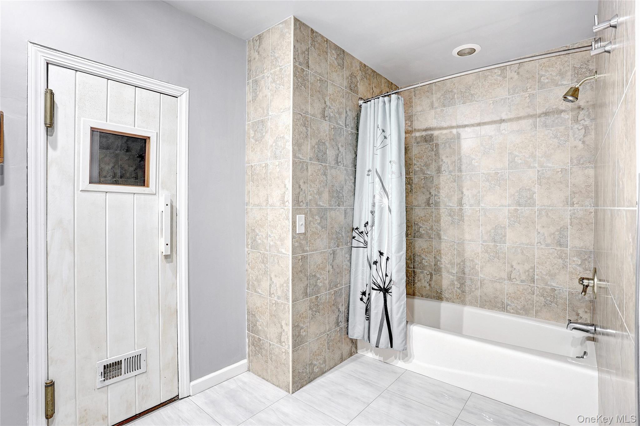 23 Sherwood Ridge Road Pomona, NY 10970 - Photo 23 of 28 a bathroom with a shower and a bath tub