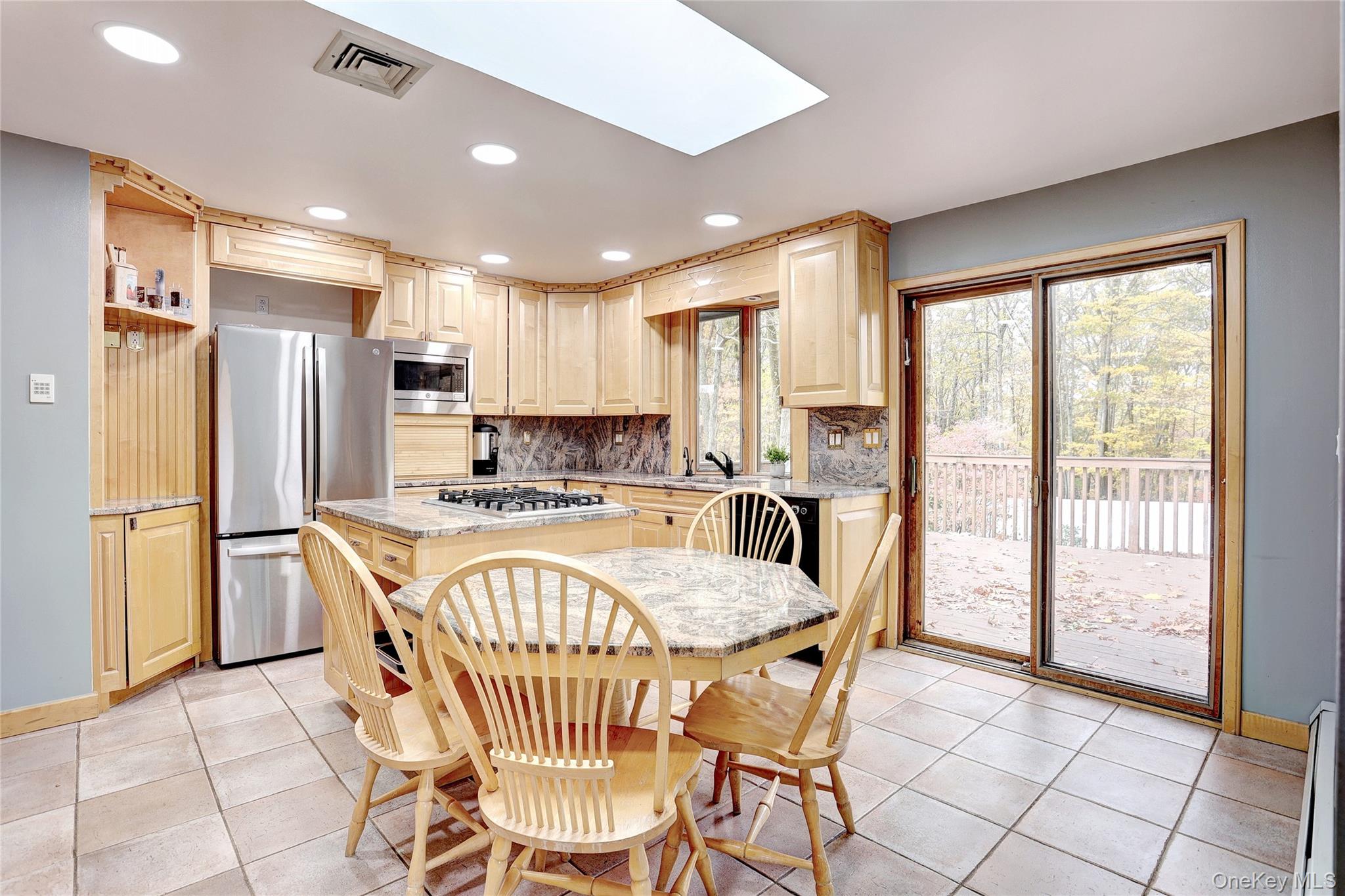 23 Sherwood Ridge Road Pomona, NY 10970 - Photo 9 of 28 a kitchen with stainless steel appliances granite countertop a refrigerator a sink a stove a dining table and chairs