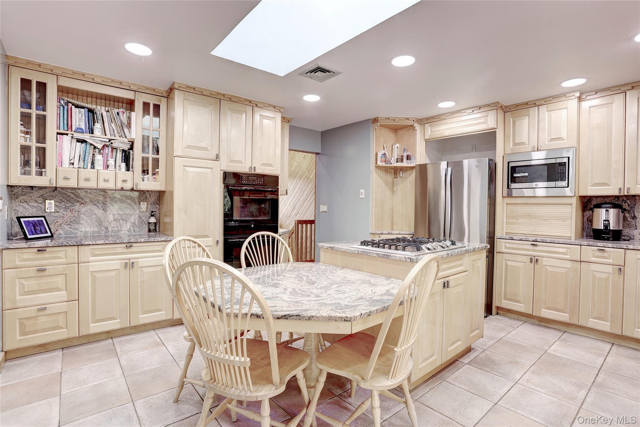 23 Sherwood Ridge Road Pomona, NY 10970 - Photo 10 of 28 a kitchen with kitchen island granite countertop a stove top oven microwave and refrigerator