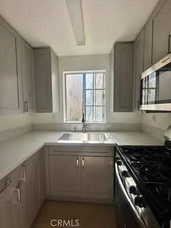 a kitchen that has a sink and a stove