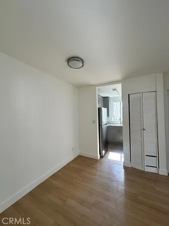 a view of a room with wooden floor and bathroom