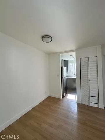 a view of a room with wooden floor and bathroom