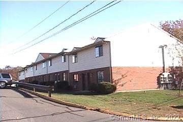 499 Scott Road, Unit 15 Waterbury, CT 06705 - Photo 1 of 1 a view of a house with a yard