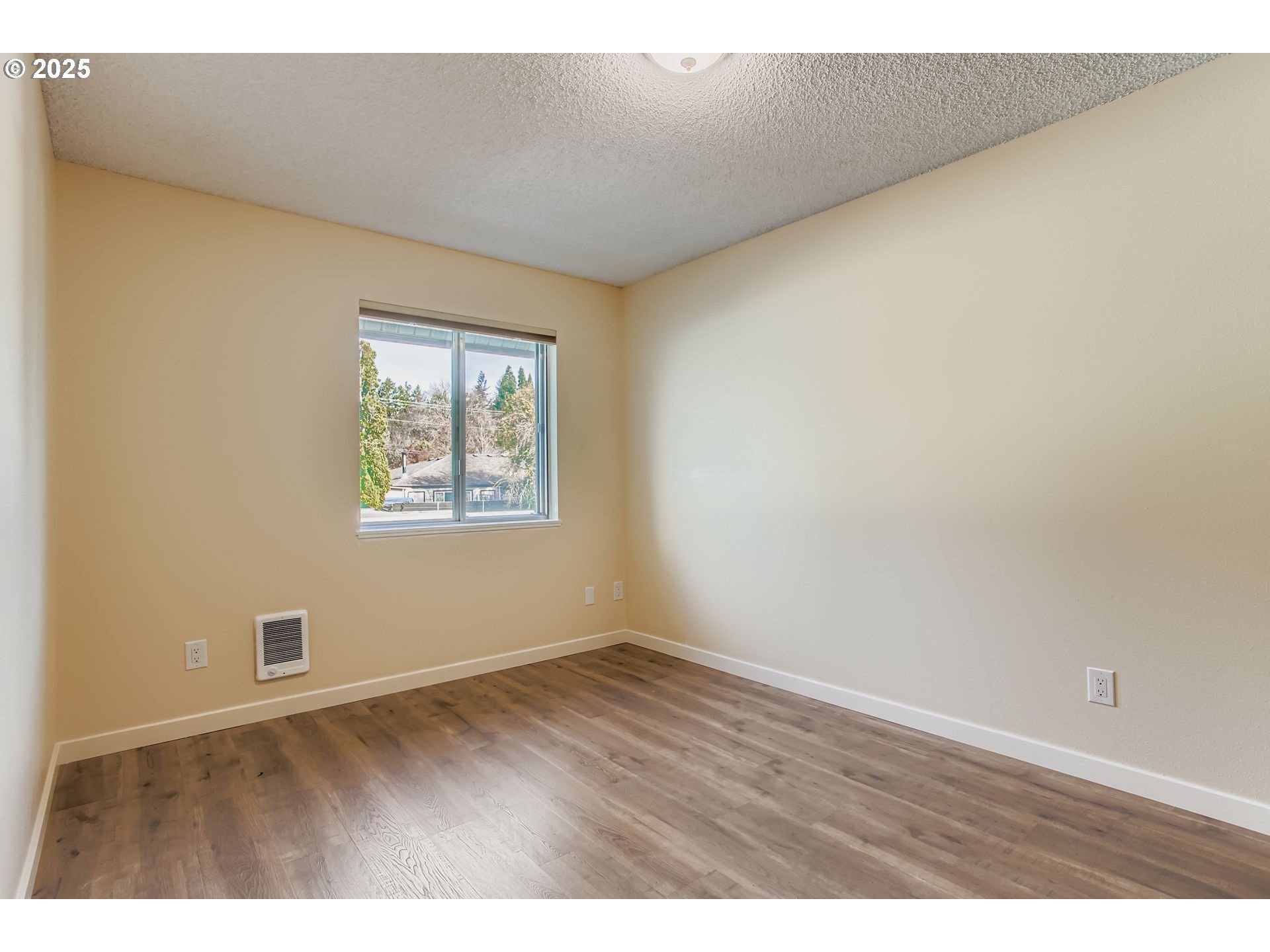 200 Southwest Florence Avenue, Unit C6 Gresham, OR 97080 - Photo 11 of 21 a view of an empty room with wooden floor and a window