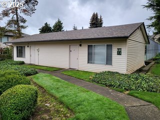 200 Southwest Florence Avenue, Unit C6 Gresham, OR 97080 - Photo 16 of 21 a view of a brick house with a small yard and a large tree