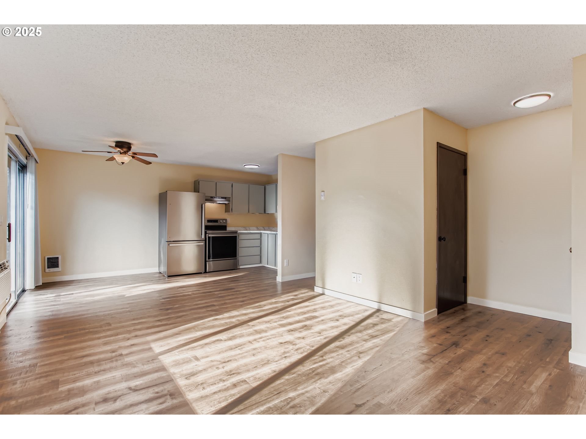 200 Southwest Florence Avenue, Unit C6 Gresham, OR 97080 - Photo 3 of 21 a view of a kitchen with wooden floor and a refrigerator