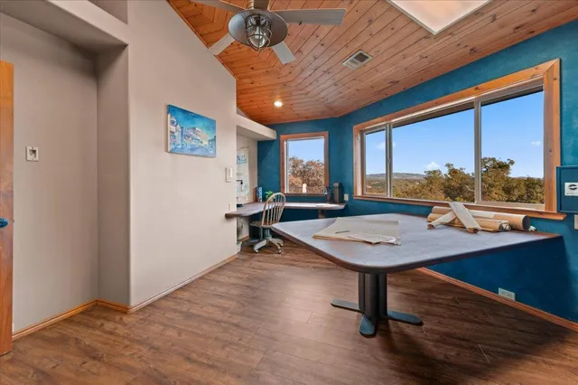 a bathroom with a granite countertop sink a toilet a mirror a bathtub and shower