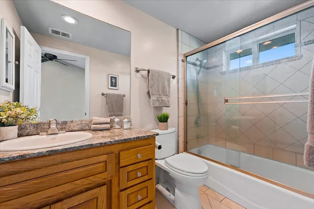 a kitchen with stainless steel appliances granite countertop hardwood floor sink stove dining table and chairs