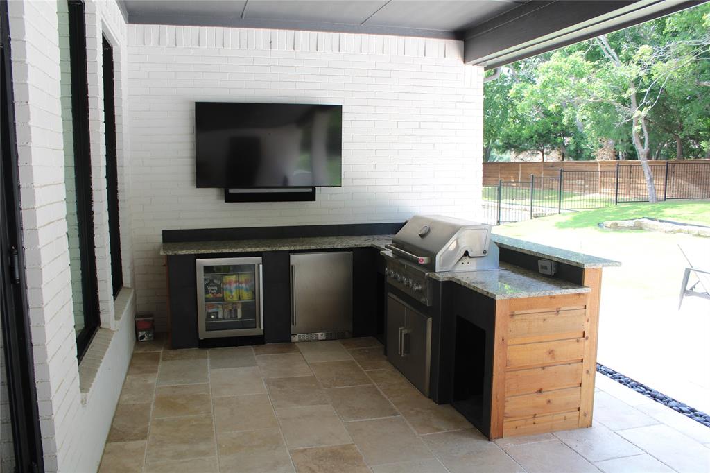 333 Renaissance Lane Heath, TX 75032 - Photo 12 of 35 Outdoor kitchen featuring a built-in grill, beverage refrigerator, and granite countertops
