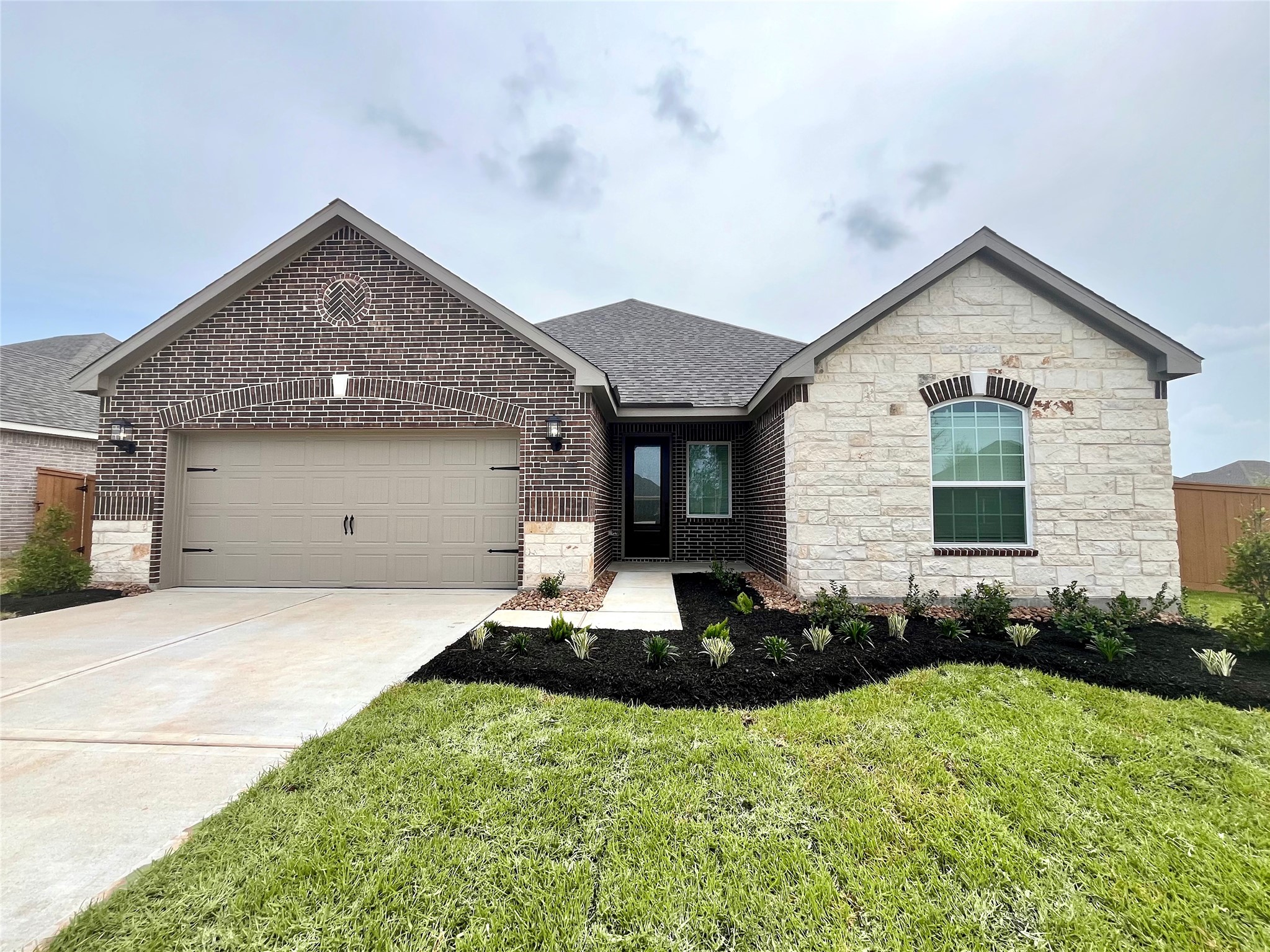 The Chatfield Plan by LGI Homes. Completed example of home to be built at 13601 Gaff Rig Drive. Actual colors and finishes may vary, completed home will not have stone and only will have brick.