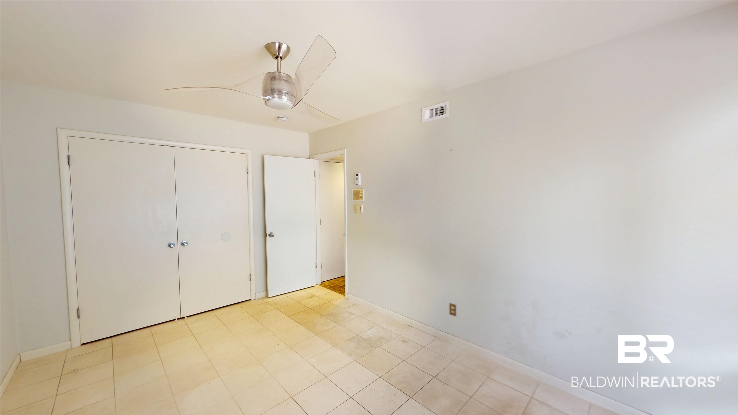 15 Spring Bank Road Mobile, AL 36608 - Photo 36 of 58 Unfurnished bedroom featuring ceiling fan, a closet, and light tile patterned flooring