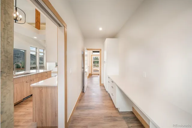 a large kitchen with stainless steel appliances granite countertop a lot of counter space and wooden floors