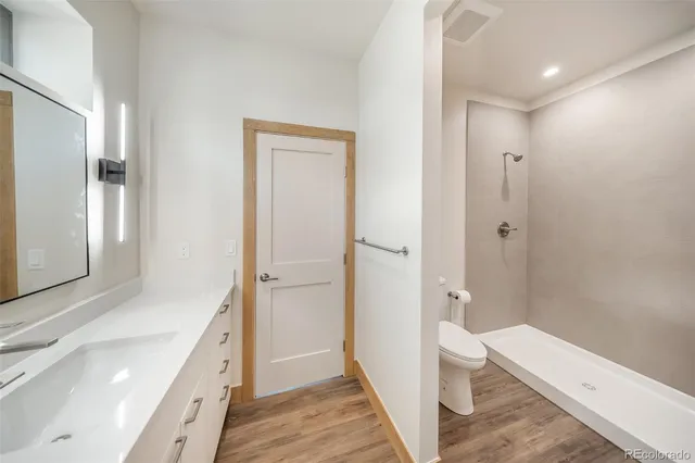 a bathroom with a toilet a sink and a shower