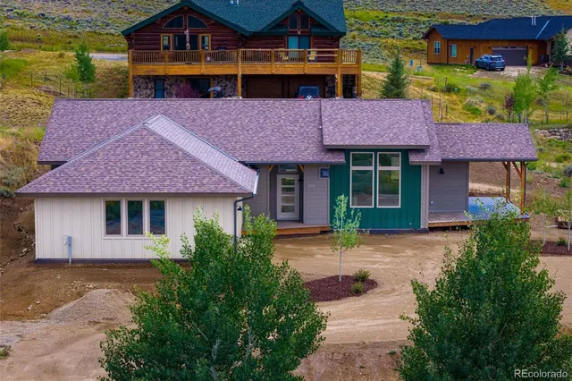 a front view of a house with a garden and sitting area