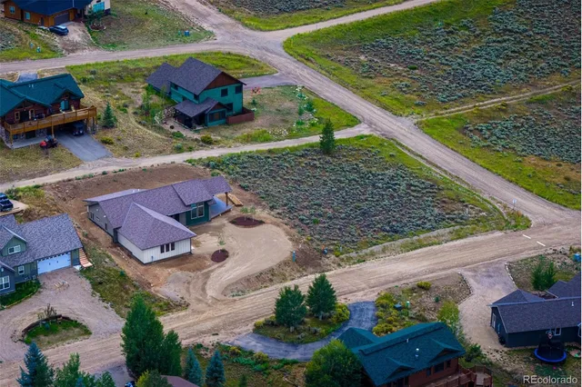 a house with green field in front of it