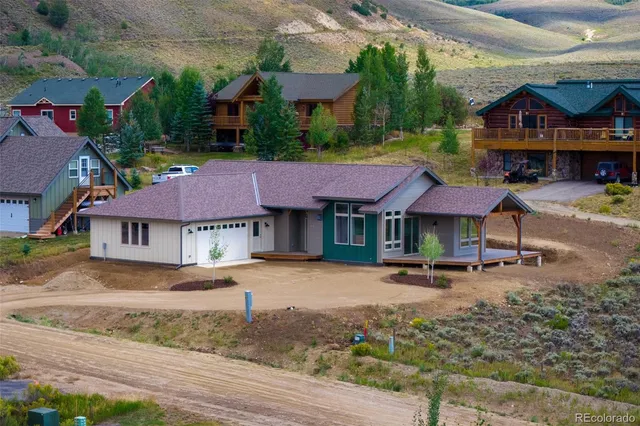 an aerial view of a house with a yard
