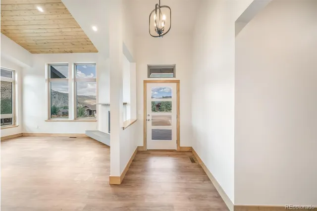 a large kitchen with stainless steel appliances kitchen island a large counter top and a wooden floors