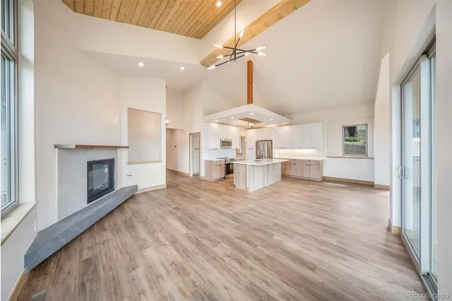 a spacious bedroom with a bed and a chandelier